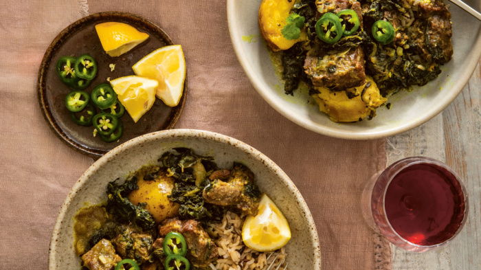 a picture of two plates filled with lamb and spinach curry
