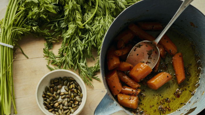 a picture of a worksurface with two plates filled with butter glazed carrots