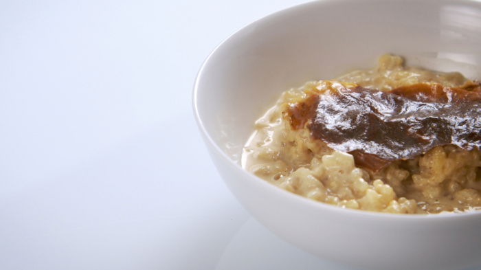 rice pudding in a bowl with a brown crinkly skin
