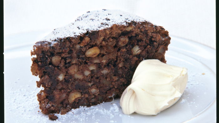 a picture of a slice of cake on a plate with a dollop of cream next to it