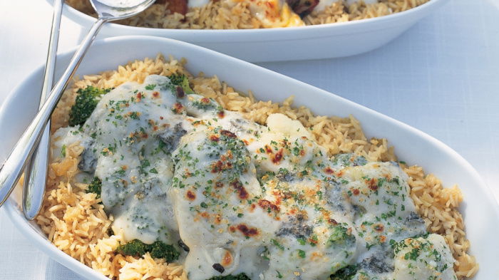 two white oval gratin serving dishes on a white tablecloth