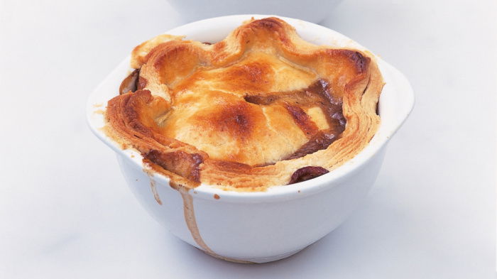 a picutre of three white bowls serving Delia Smith's recipe for individual steak mushroom and kidney pies
