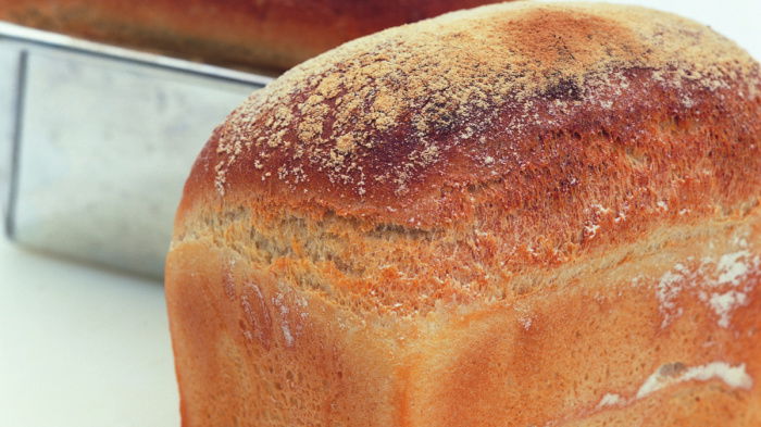 picture of two white loaves, one in a tin