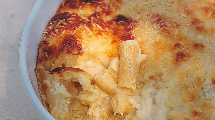A close up picture of a white dish containing cooked macaroni cheese