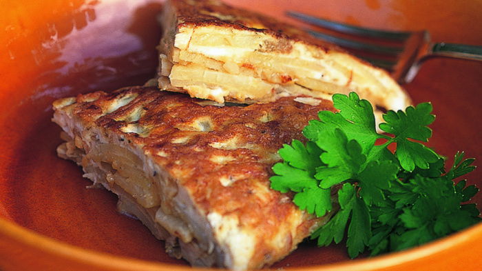 picture of a bowl with slices of tortilla and a garnish