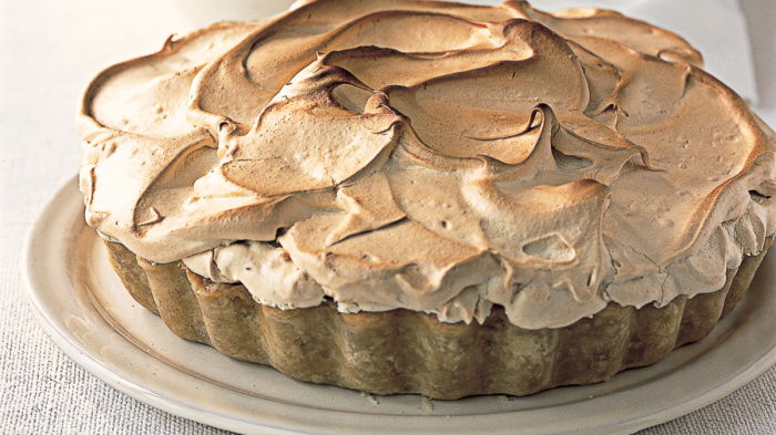 a white plate with a orange and rhubarb meringue pie
