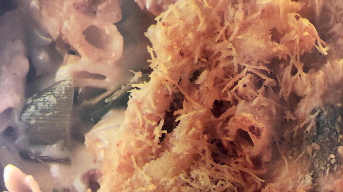 a bowl of penne pasta with leeks and bacon