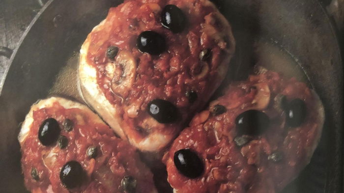 four pieces of fish in a frying pan