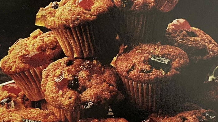 A picture of ten mini mincemeat muffins all piled up on a wire tray