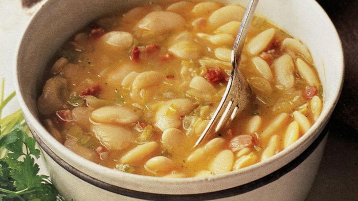 A bowl of thick butterbean soup with a fork resting on the side