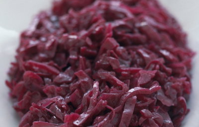 a picture of an oval white china dish of shredded, braised red cabbage