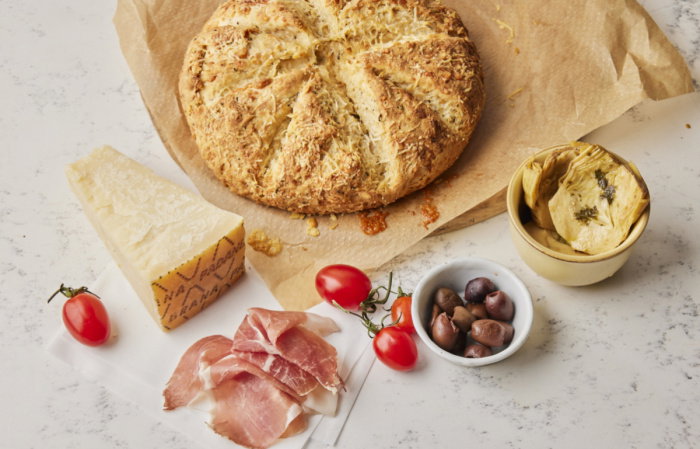 a picture of Grana Padano cheesy bread on a wooden breadboard 