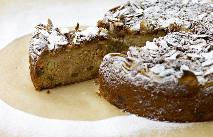 a picture of a spiced apple cake with a slice taken out