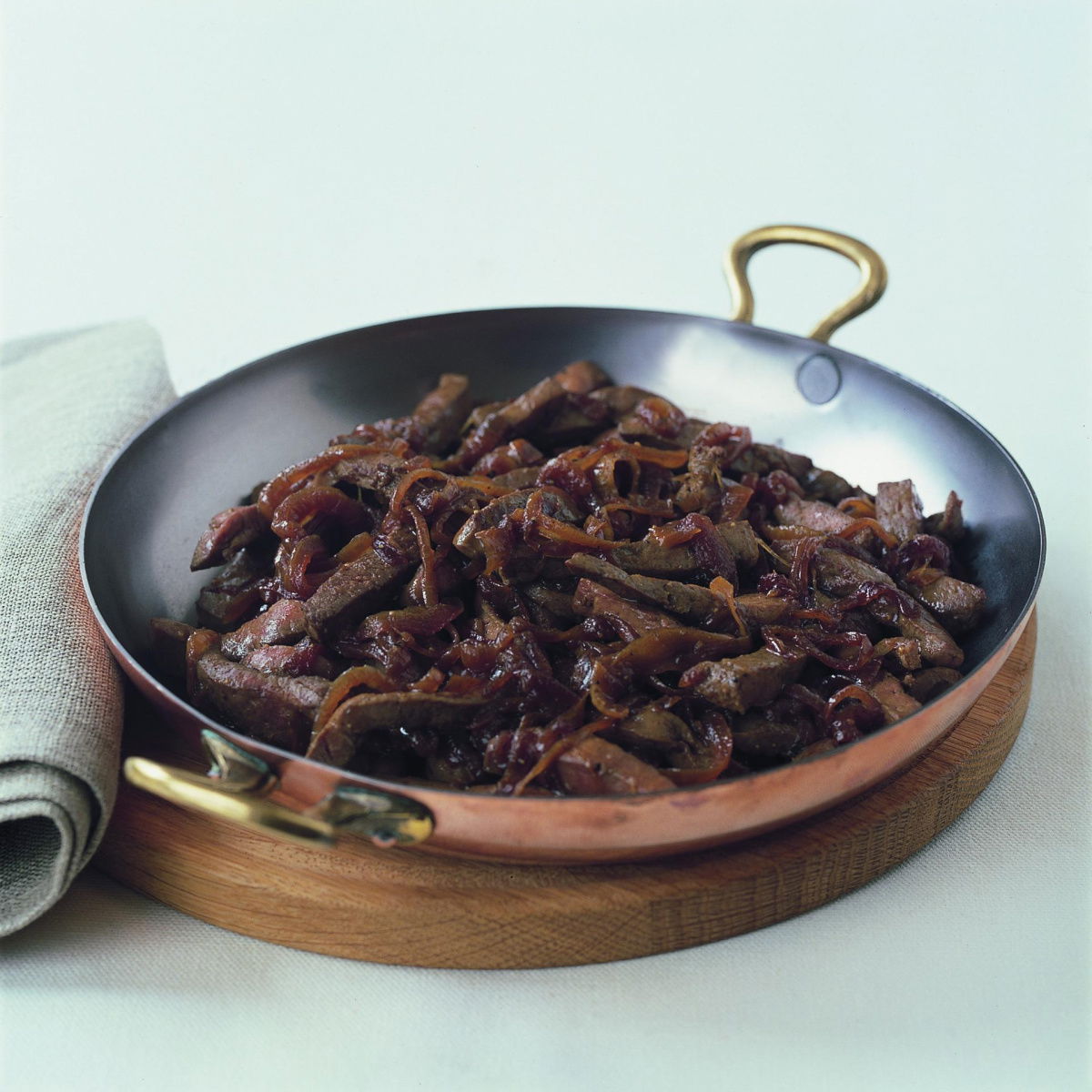 a picture of cooked sliced liver in a metal ovenproof dish