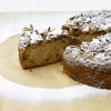 a picture of a spiced apple cake with a slice taken out