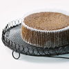 a cooked parkin cake in a pleated case sitting on a wire cooling tray