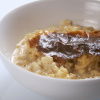 rice pudding in a bowl with a brown crinkly skin