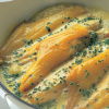 a picture of cooked haddock fillets in a white oven dish