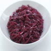 a picture of an oval white china dish of shredded, braised red cabbage