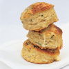 a picture of three stacked buttermilk scones on a white napkin