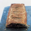 A picture of mincemeat mixture inside a puff pastry case on a baking sheet