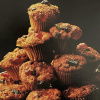 A picture of ten mini mincemeat muffins all piled up on a wire tray