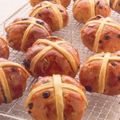 individual hot cross buns on a wire cooling rack