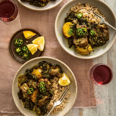 a picture of two plates filled with lamb and spinach curry