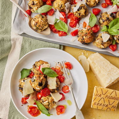 White plate and baking tray with Grana Padano cheese
