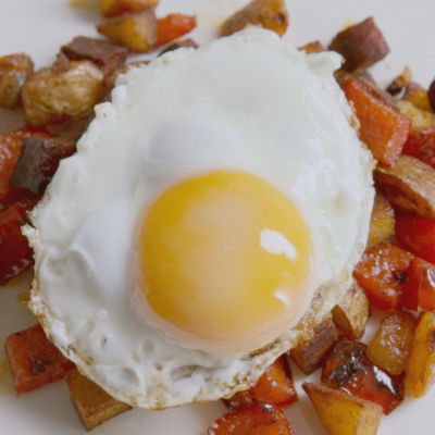 a picutre of crispy diced cooked chorizo and potatoes with a fried egg on top