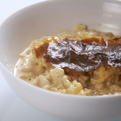 rice pudding in a bowl with a brown crinkly skin