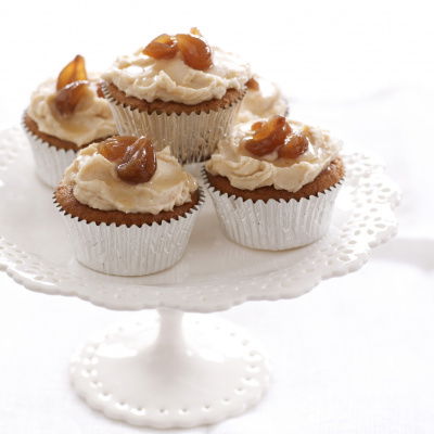 a pretty white cake stand with four chestnut cupcakes in silver muffin cases