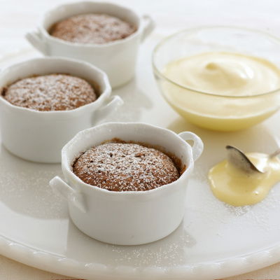 a picture of three little white dishes of sabayon on a white plate with a glass dish of sabayon sauce and teaspoon on the side