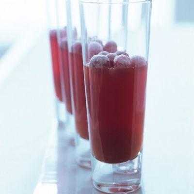 a picture of four long glasses half full of creanberry jelly with frosted jellies resting on the top
