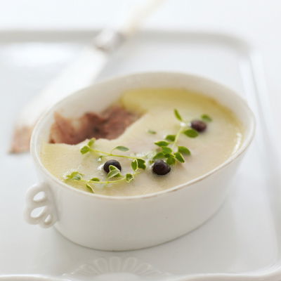 a picture of a white oblong dish of pate with a garnish on the top sitting on a square white china plate