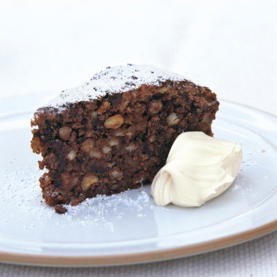 a picture of a slice of cake on a plate with a dollop of cream next to it