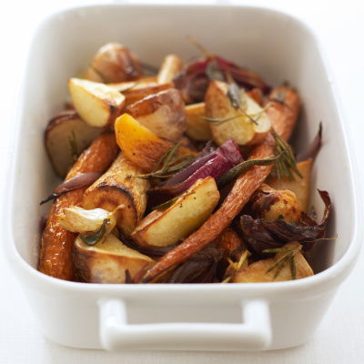 A picture of roasted root vegetables in a white oven dish