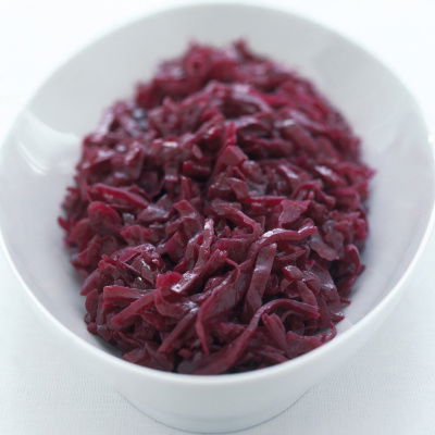 a picture of an oval white china dish of shredded, braised red cabbage