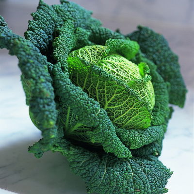 A vibrant green cabbage with light and dark shades