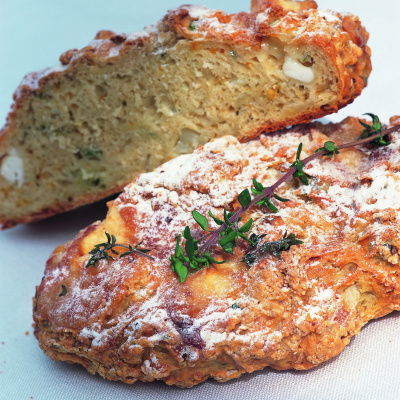 a picture of a loaf of goats cheese and thyme bread cut in half