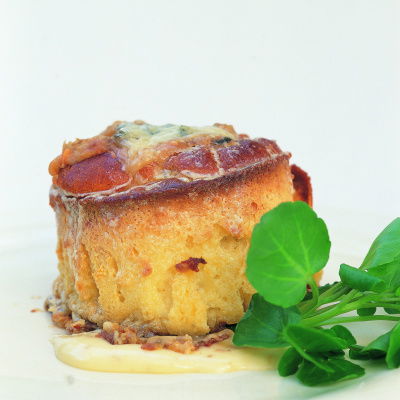 a picture of a cooked souffle with sauce and garnish