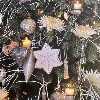 a picture of a christmas tree full of decorations and candles