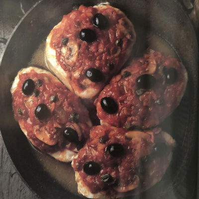 four pieces of fish in a frying pan